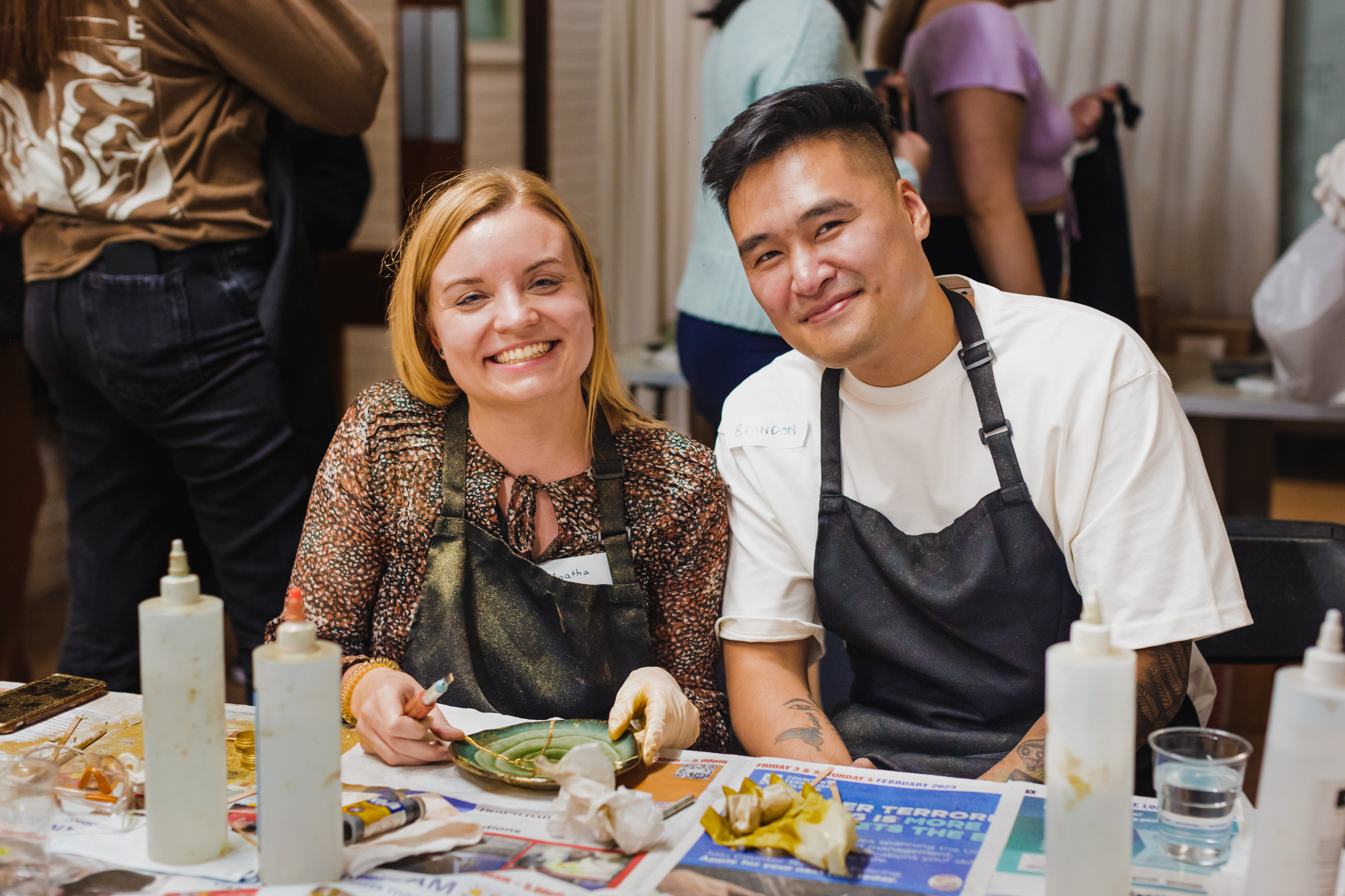 Smiling man and women at a kintsugi workshop